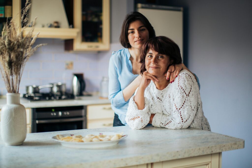 Good Mother-in-Law and a Peaceful Family A loving moment shared between mother and daughter in a cozy kitchen, depicting warmth and bonding.